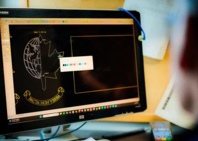 Computer screen with CAD design, blurry figure in foreground, and color swatches visible.