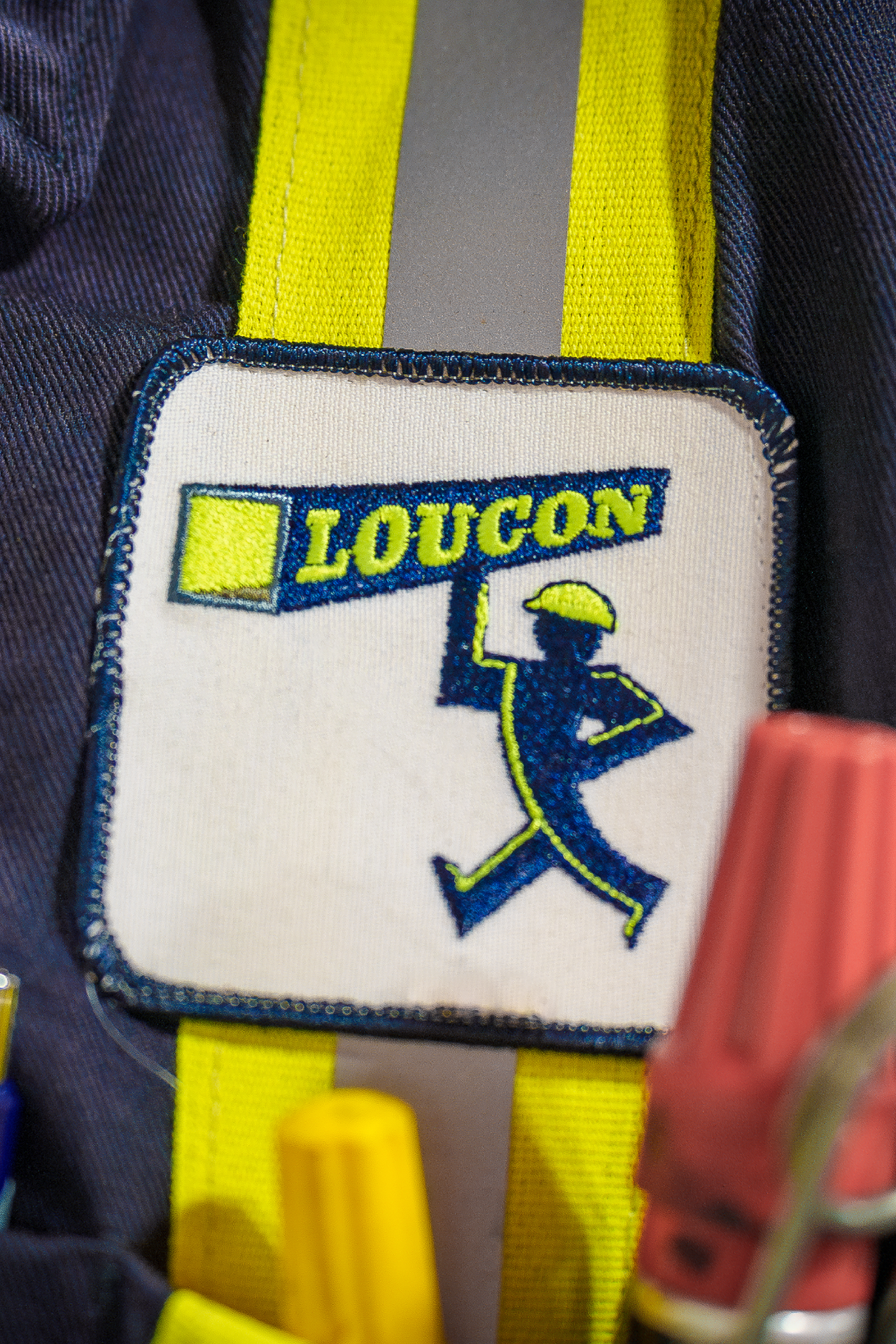 A blue jacket with prominent yellow and white stripes, highlighting a trendy and colorful appearance